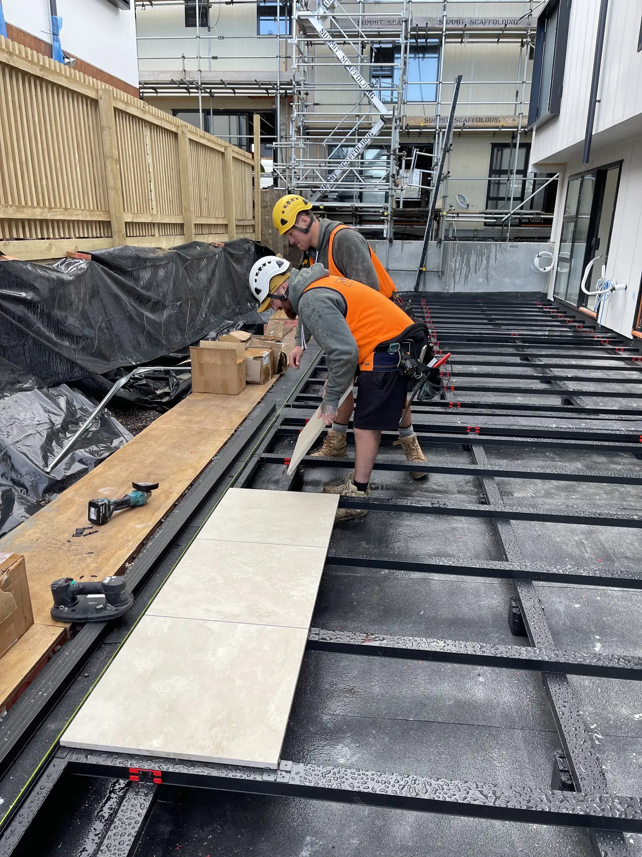 Porcelain pavers going down on an aluminium frame