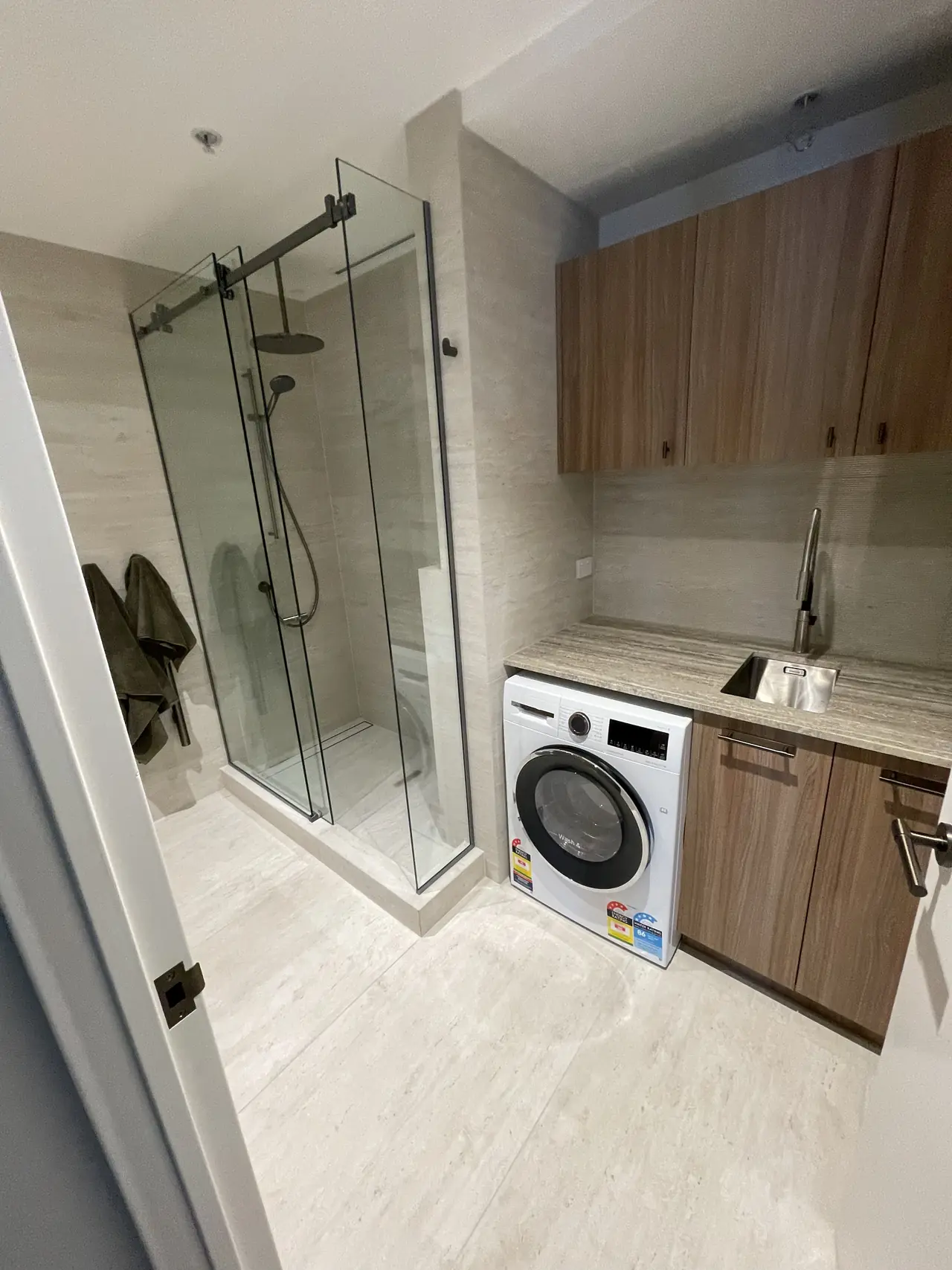 Bathroom and laundry tiled floor to ceiling