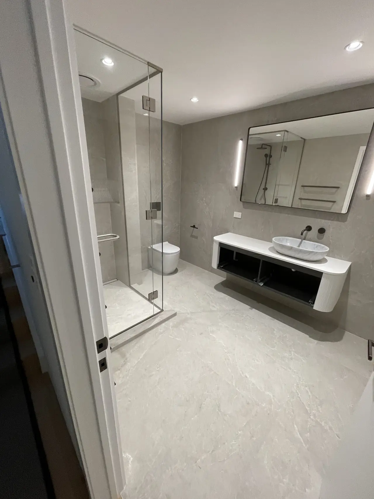 Large format grey bathroom with walk-in shower