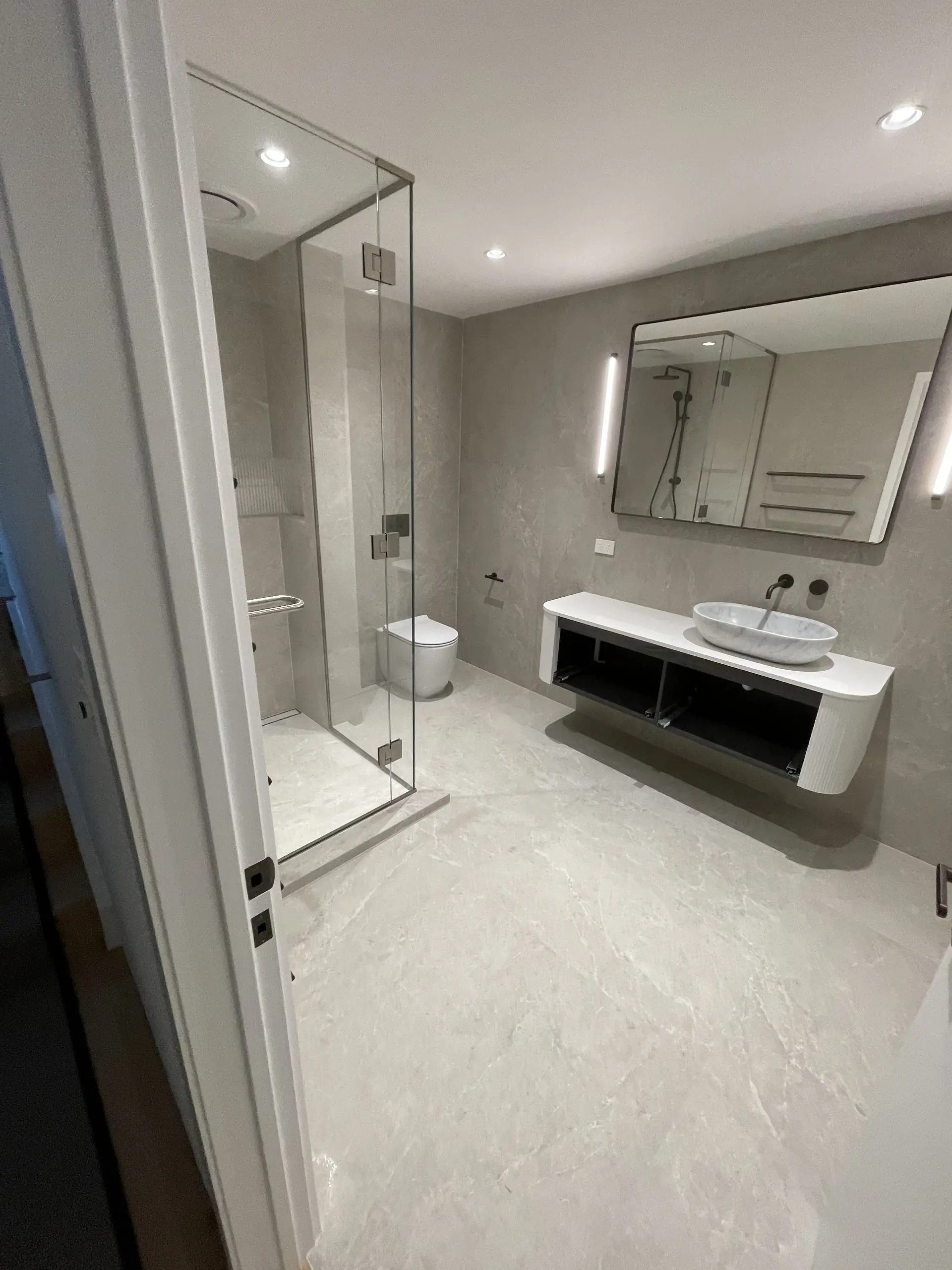 Large format grey bathroom with walk-in shower