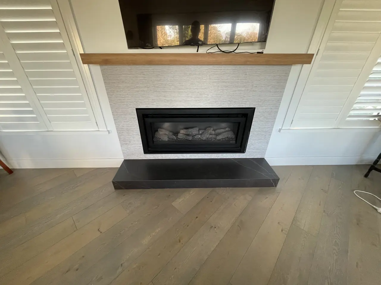 Tiled fireplace with dark stone hearth