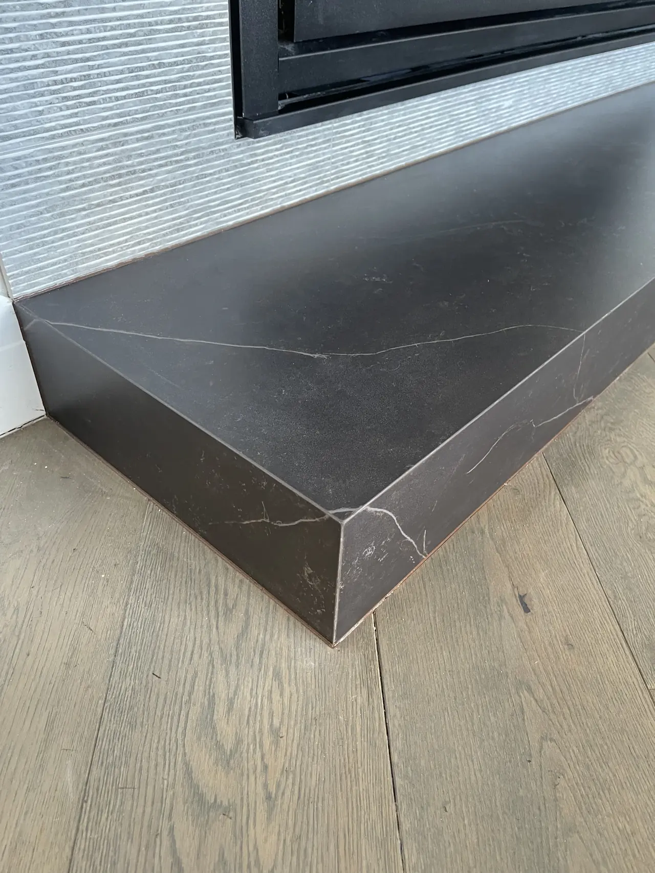Mitred stone-look hearth step detail