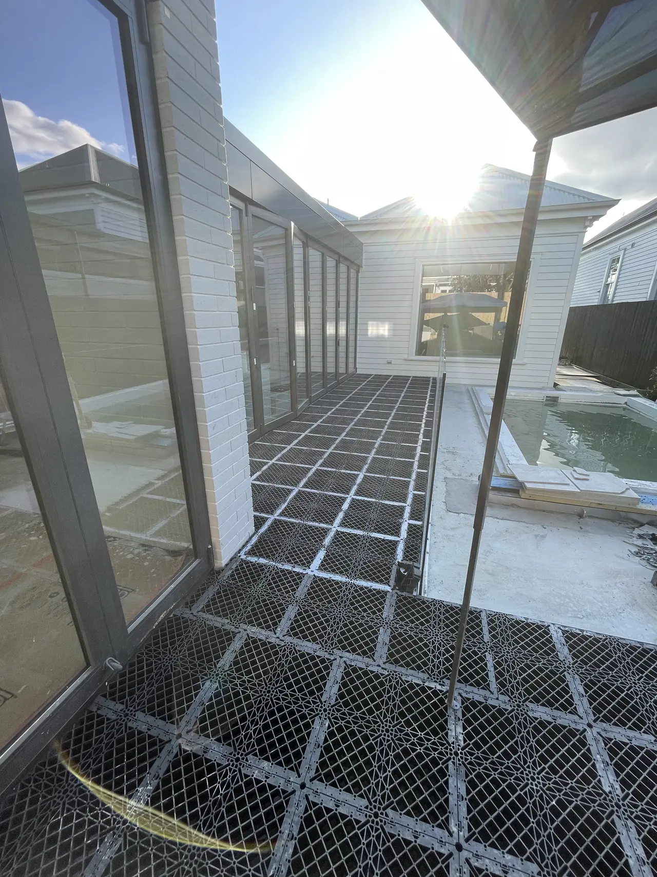 Nuragrid walkway beside glass balustrade