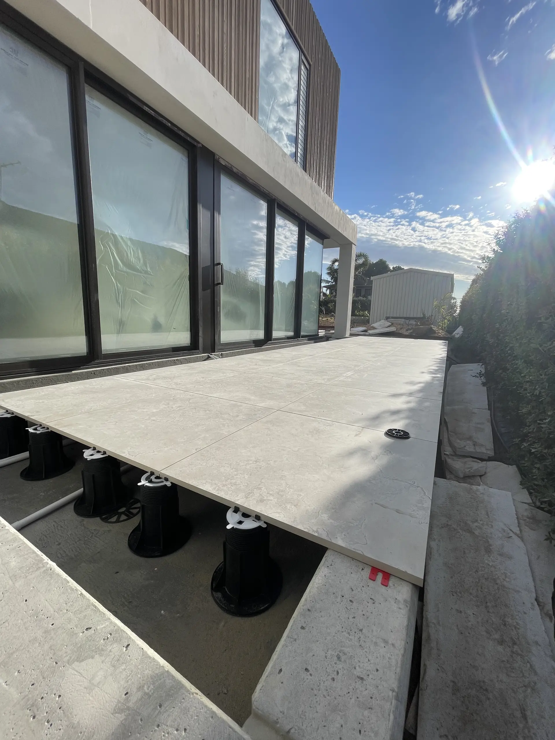 Porcelain deck on adjustable pedestals