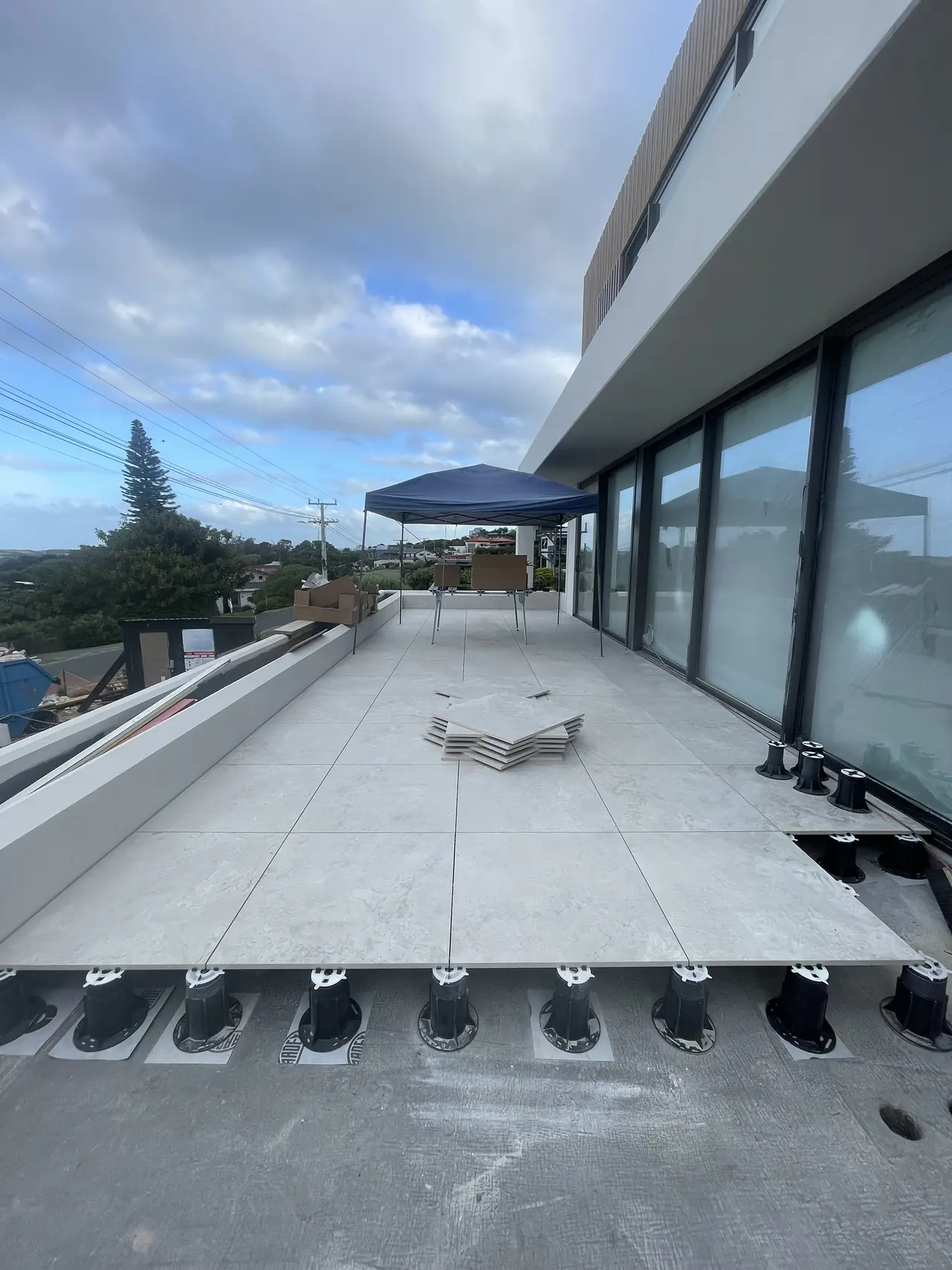 Adjustable pedestals under a raised deck