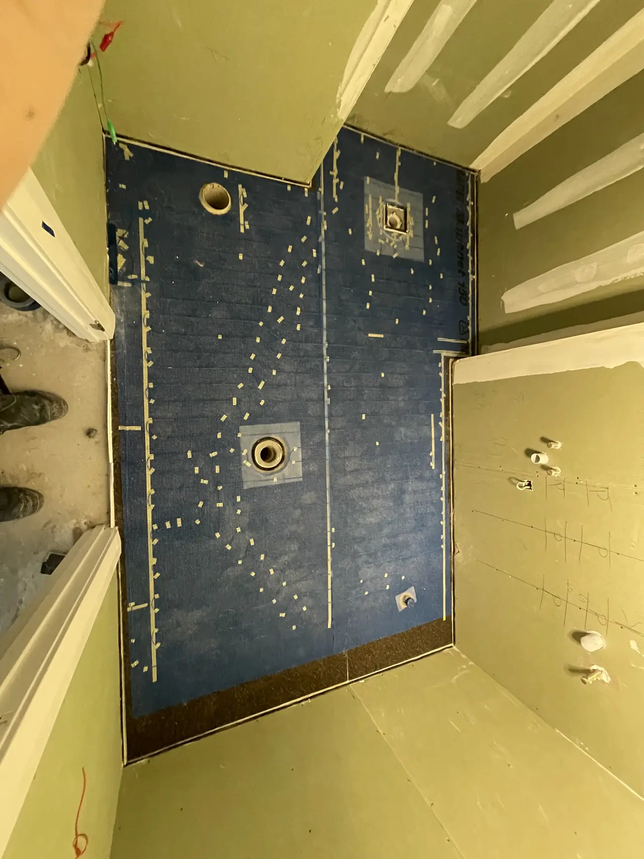 Shower waterproofing with reinforcing tape at joints